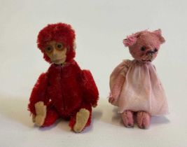 Two miniature Schuco animals, comprising a red monkey compact with internal mirror and puff, and a