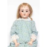 A large Schoenau & Hoffmeister bisque socket head doll, with brown glass sleeping eyes, oepn