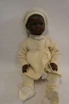 An Armand Marseille bisque socket head baby doll, with brown glass sleeping eyes, closed mouth,