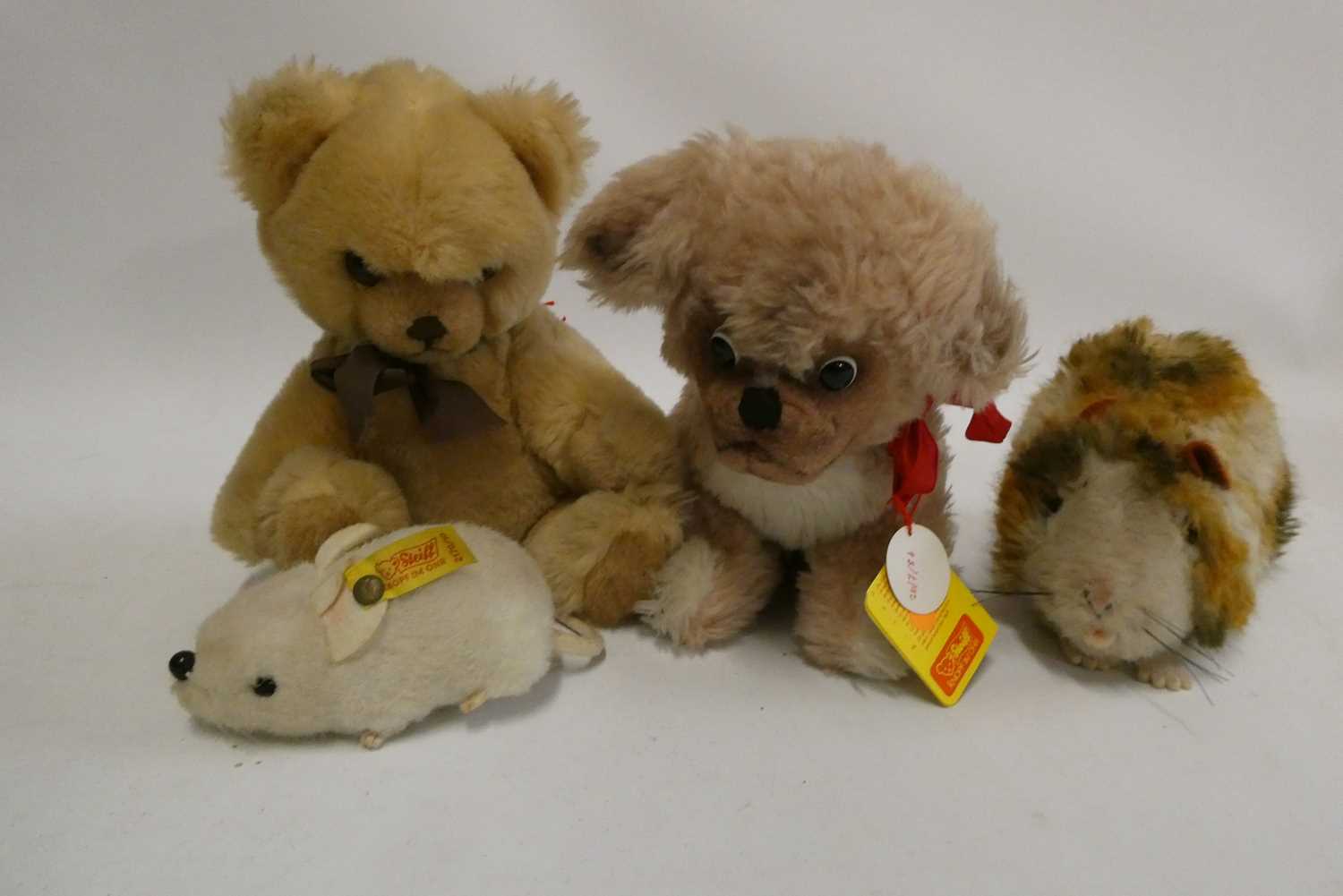 Four Steiff plush toys, comprising a Petsy dog, with googly eyes and white metal ear button, 11"