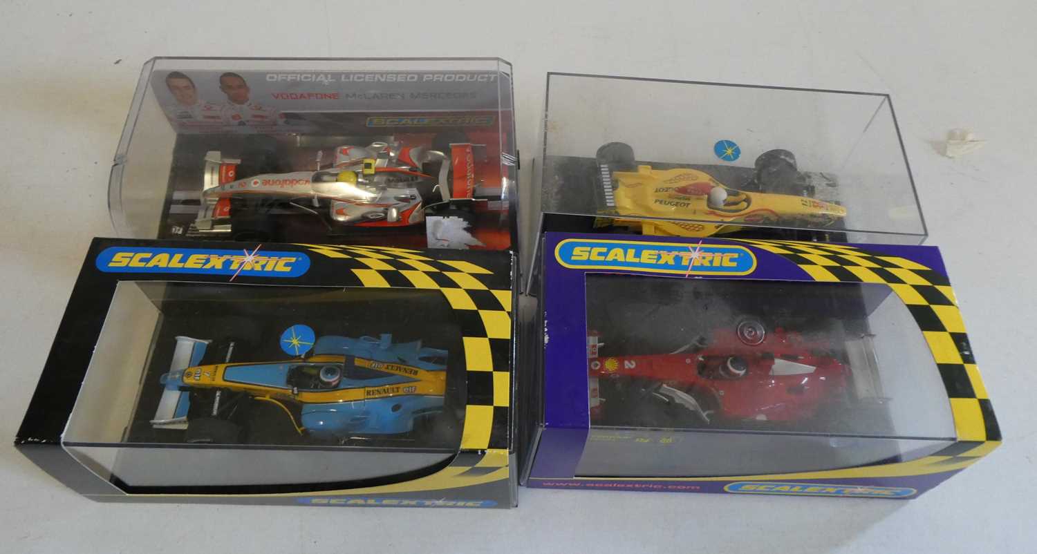 Four Scalextric Formula One race cars including Ferrari, Mclaren and Renault, all items boxed,