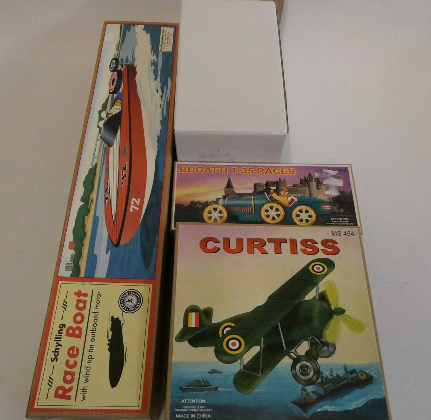 Four late issue tinplate toys comprising of speed boat, Bugatti Racer, Curtiss airplane and Schuco