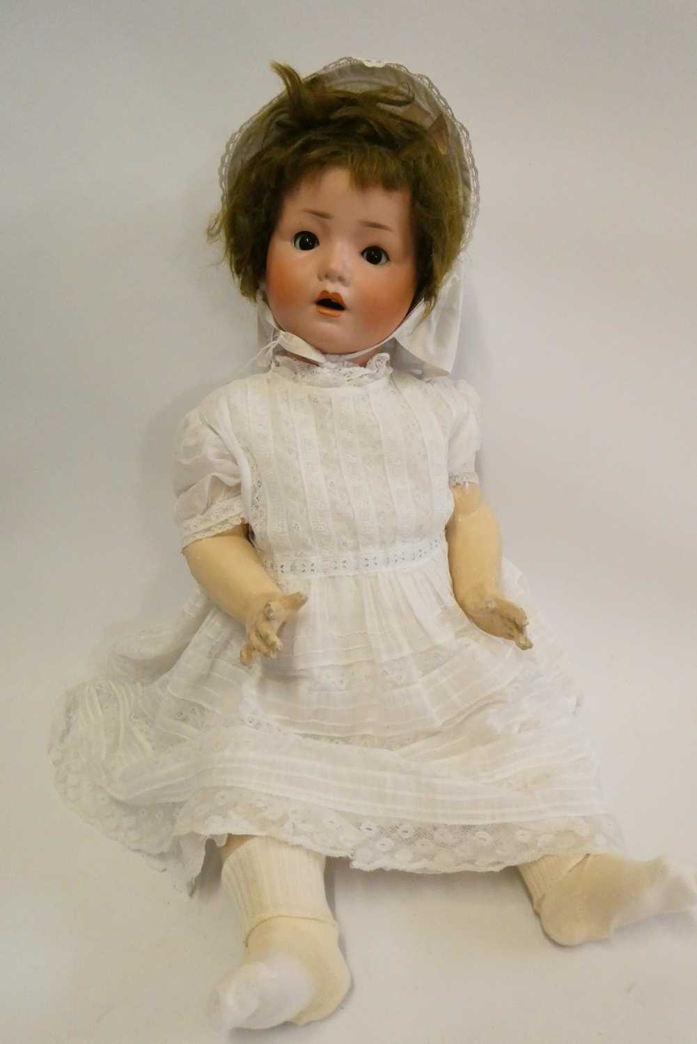 A Schoenau & Hoffmeister bisque socket head doll, brown glass sleeping eyes, open mouth, composition