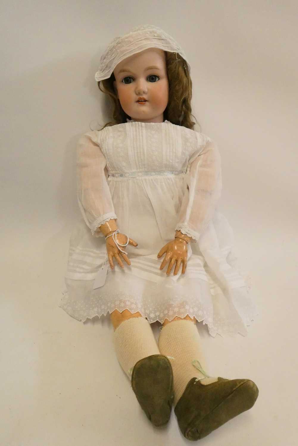 A large Armand Marseille bisque socket head doll, with blue glass sleeping eyes, open mouth,