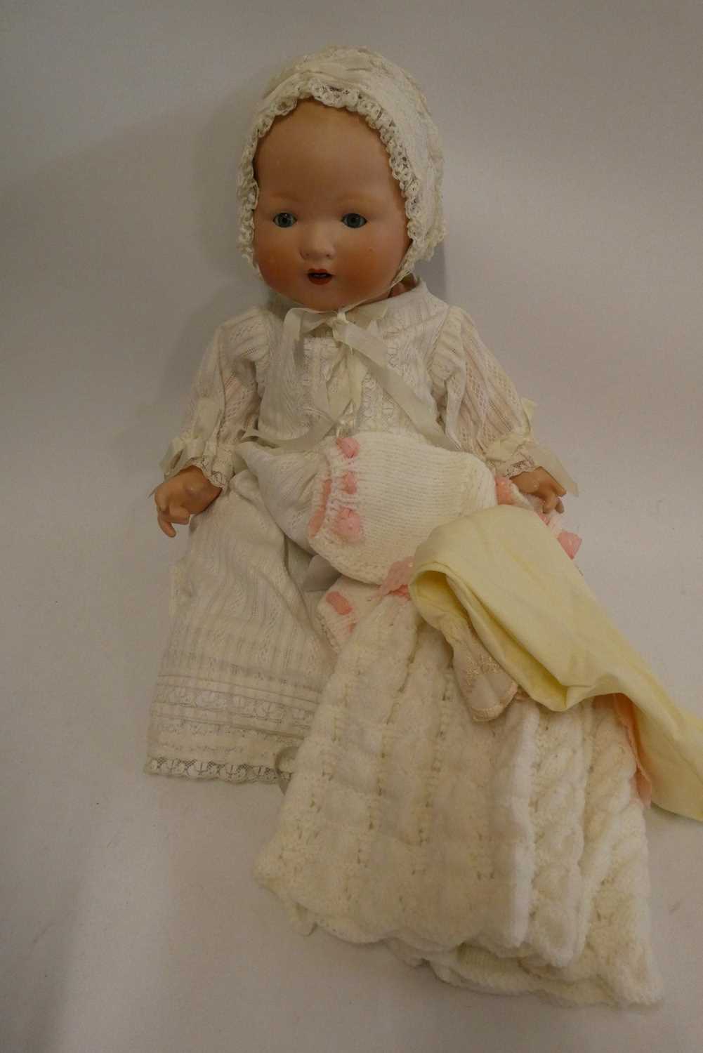 An Armand Marseille bisque socket head baby doll, with blue glass sleeping eyes, open mouth,