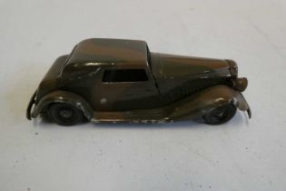 Minic clockwork hand painted camouflage saloon car, one front headlight missing, good