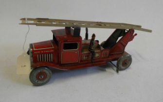 Mettoy clockwork fire engine with escape ladder and three firemen. Overall condition excellent,