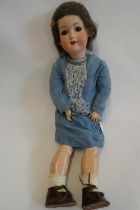 An Armand Marseille bisque socket head doll, with brown glass sleeping eyes, open mouth, teeth, wood