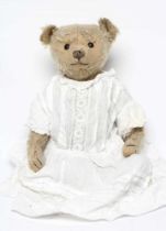A centre seam early steiff teddy bear, c.1904, with black button eyes, straw filling, sewn nose,
