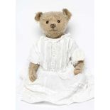 A centre seam early steiff teddy bear, c.1904, with black button eyes, straw filling, sewn nose,