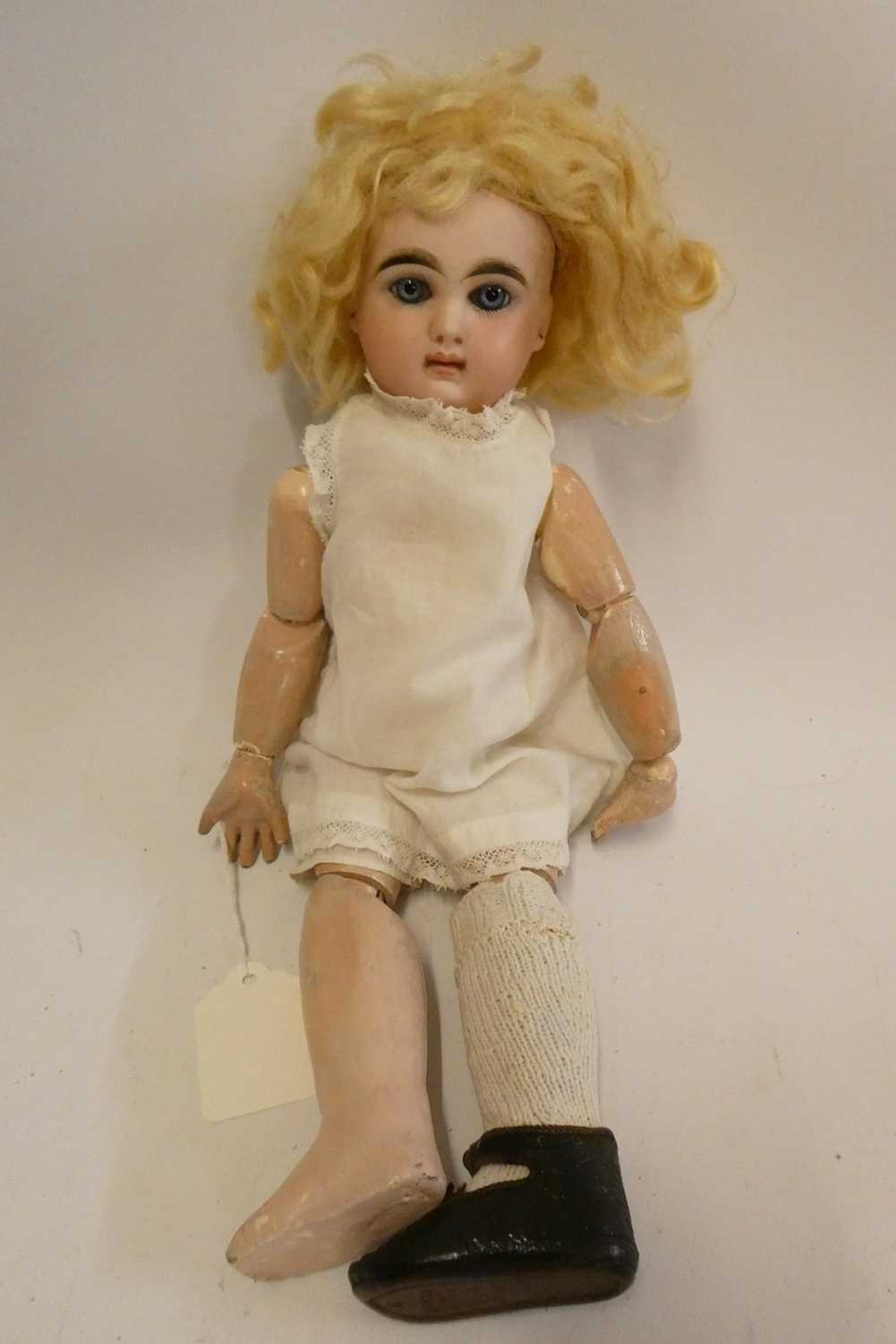 A French bisque socket head girl doll, with blue glass fixed eyes, moulded closed mouth, pierced