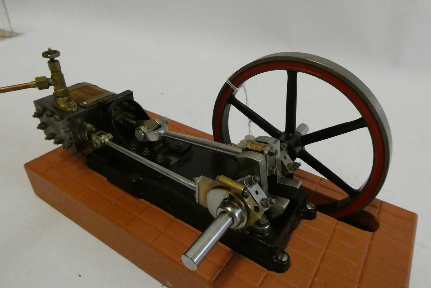 A Reeves Engineering Unicorn horizontal single cylinder non reversing mill engine, mounted on wooden