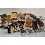 A collection of doll's house furniture and dolls, including wardrobes, dining tables chairs,