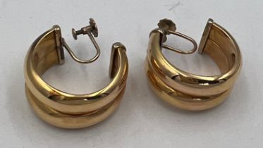 A pair of half hoop screw on earrings, marked 9 carat to screw end. Hoop unmarked. Weight 9.5gm.