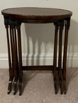 An Edwardian nest of three mahogany oval topped tables. Largest 67cm h x 56cm w x 38cm d.