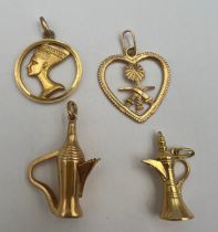 Four 18 carat yellow gold pendants to include two Arabian pitchers, Nefertiti 2.5cm d and Saudi