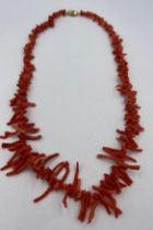 A coral necklace, 52cm l, weight 38gm with yellow metal barrel fastening.