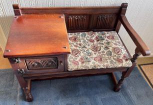 An Old Charm oak telephone table with seat and cupboard to the side. 93cm l x 47cm d x 74cm h.