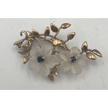 A 9 carat gold brooch set with glass and sapphires. Weight 5.4gm. Approximate size 4.2cm x 2.8cm. P