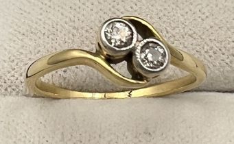 An unmarked yellow metal ring set with two diamonds. Size K. Weight 1.9gm.