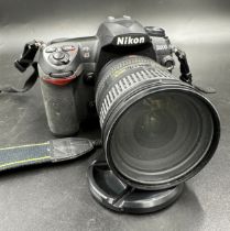 A Nikon D200 camera with Nikon DX AF-S Nikkor 18-200mm f/3.5-5.6 G ED VR Lens. In Toshiba camera