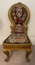 A 19thC giltwood child’s chair with original woolwork tapestry back and seat on cabriole legs.