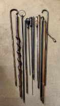 A collection of canes and sticks, two with silver hallmarks to handles, three white metal tops/