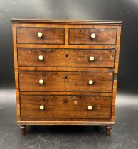 A 19thC mahogany apprentice collector's chest of drawers, two short over three graduated long