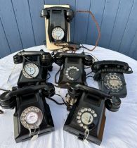 A collection of black coloured telephones including G.P.O.