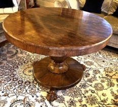 A 19thC rosewood tip-top centre table with lions paw feet. 105cm d x 72cm h.