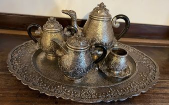 An Indonesian ? white metal teaservice comprising tray, teapot, milk, sugar and container with