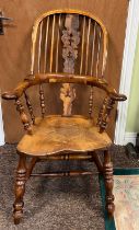 A high backed yew wood Windsor broad arm chair. 110 cm h to back. Bearing name to underside W.