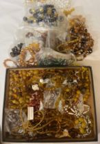 A box of vintage mainly orange and brown glass beads.