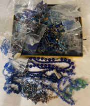 A boxed quantity of vintage blue glass and other beads to include lapis.