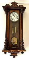 A 19thC double weight walnut Vienna wall clock. 108cm h.