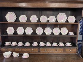 A Wileman & Co. Foley china tea service comprising 12 cups, 12 saucers, 12 plates, 2 bread and