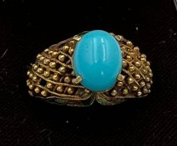A 14 carat gold ring set with turquoise stone with enamel decoration to the sides. Size N, weight