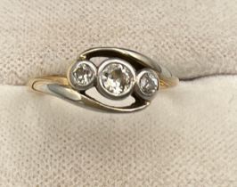 An unmarked yellow and white metal ring set with three diamonds. Size J/K. Weight 2.4gm.