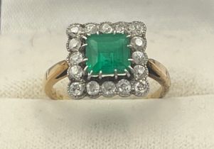 A square cut emerald and diamond ring set in unmarked yellow and white metal. Head size
