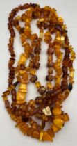 Four amber coloured bead necklaces.