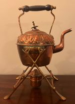 A 19thC copper kettle on stand with burner.