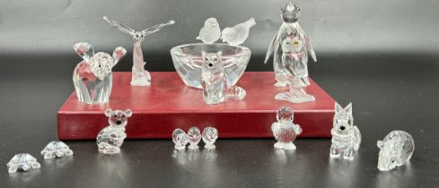 A collection of 12 Swarovski Silver Crystal boxed ornaments to include penguin, owl, turtles, cat,