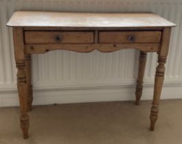 A 19thC pine side table with two drawers to front. 97cm w x 43cm d x 74cm h.