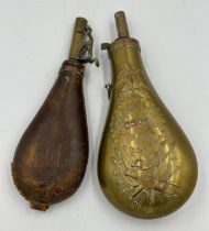 Two brass powder flasks, one leather bound, the other US Army with raised decoration largest