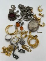 A quantity of costume jewellery to include hallmarked silver locket, earrings, rings etc.