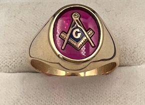 A 14 carat gold Masonic ring with synthetic ruby and Masonic symbol. Size R/S. Weight 7.2gm.