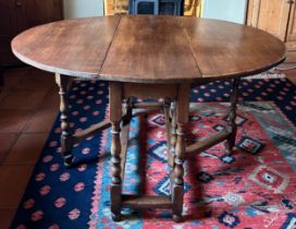 An oak gateleg dining table. 108cm w x 39cm d x 74cm h, closed, open 135cm l.
