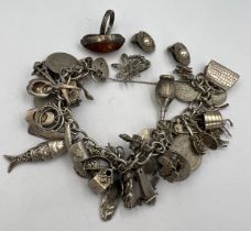 Silver charm bracelet and multiple silver charms, some opening, pair of marcasite set earrings, a