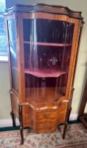 A mahogany inlaid and brass mounted vitrine with central door and shaped glass panels. Two drawers