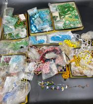 A large collection of various vintage glass and other coloured beads. Some in need of re threading.